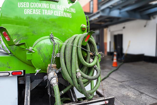 a vacuum truck pumping out a large underground grease trap in Essex